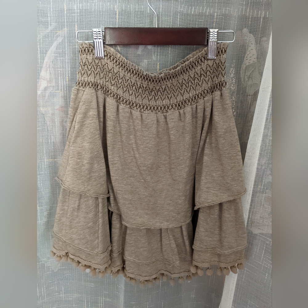Tan layered skirt with pom poms by Ryu